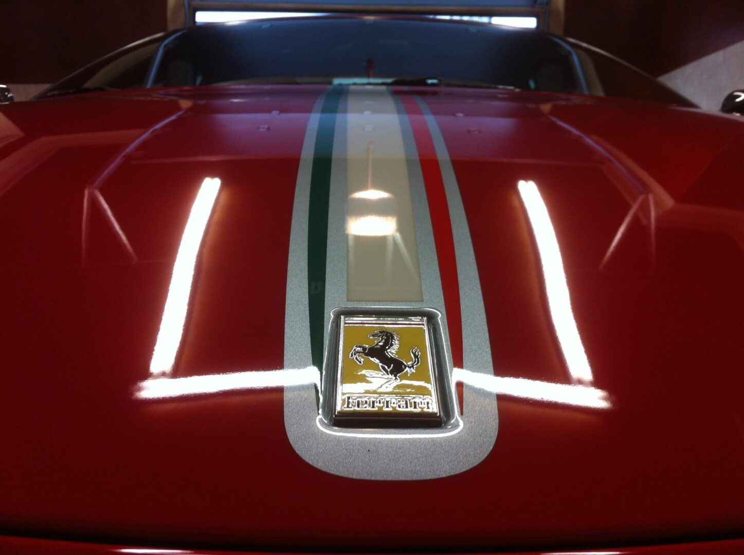 Front hood of a shiny red Ferrari car